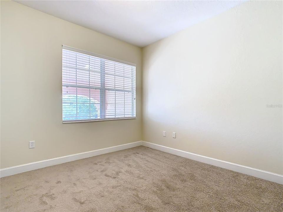 The window looking out to the front of the home in this guest bedroom.