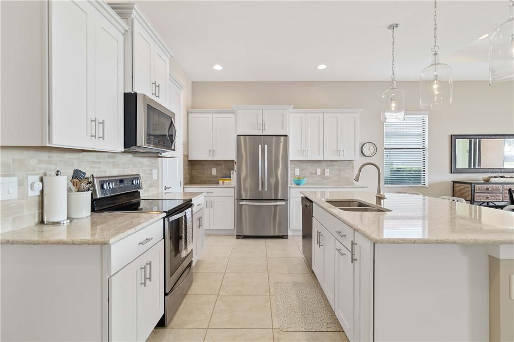 Kitchen - white cabinetry, granite counters