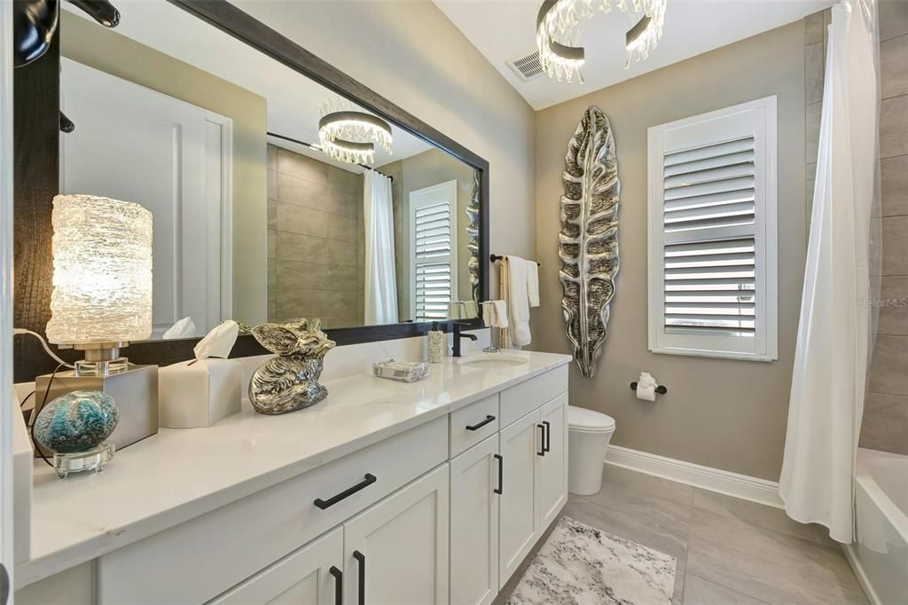 Second bathroom with framed mirror