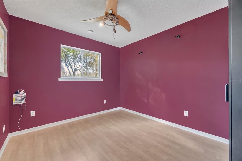 Secondary bedroom with beautiful wood flooring