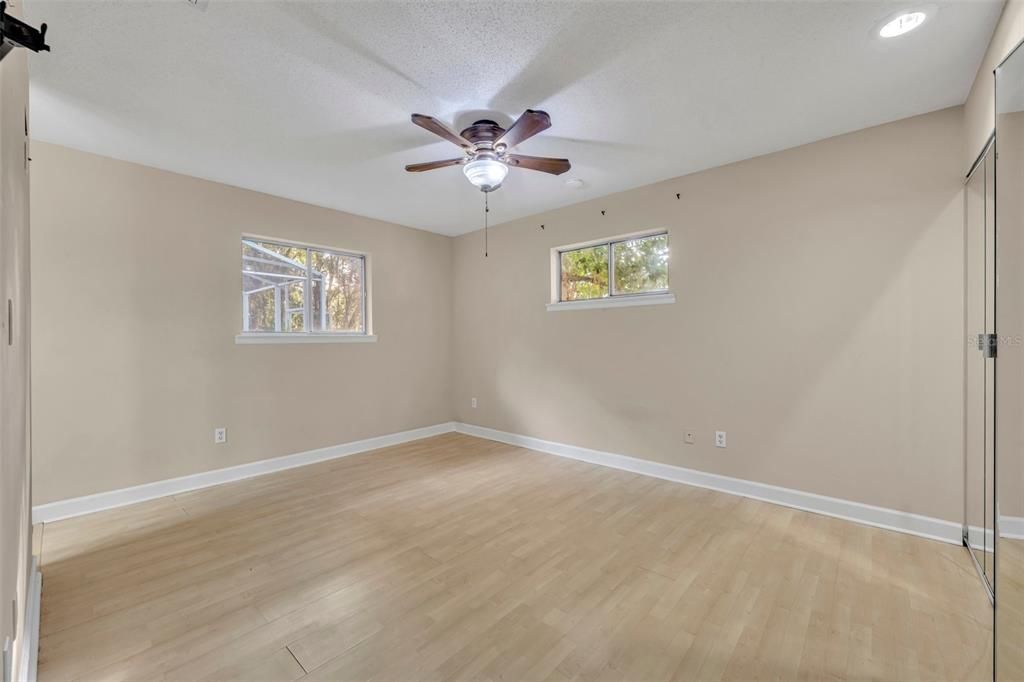 Primary bedroom has plenty of windows for natural lighting!