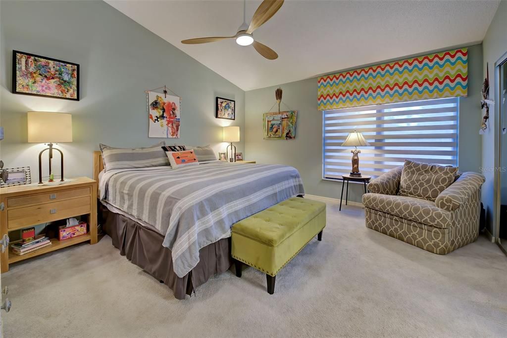 The primary bedroom with vaulted ceilings is large and nicely carpeted.