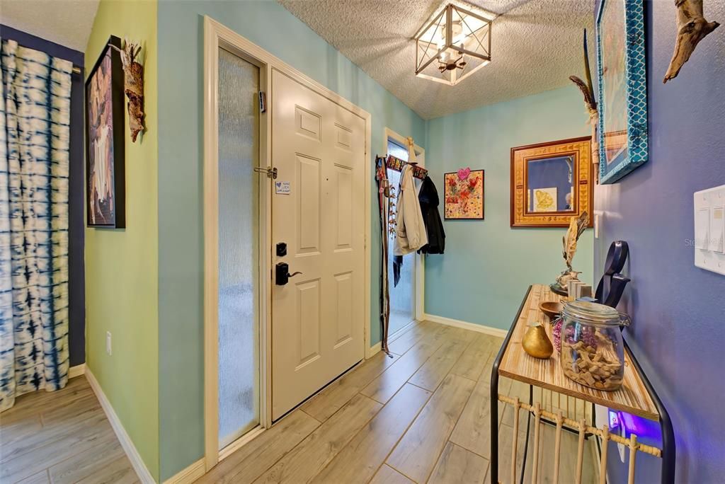 This is the front door from the inside of the home.  It has beautiful plank tiles.