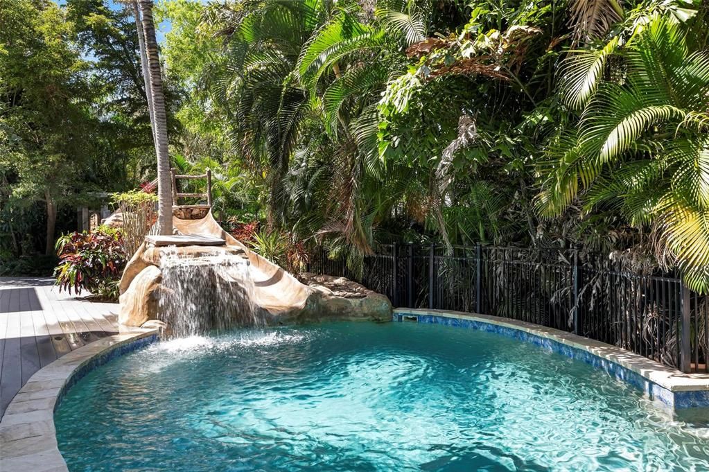 Outdoor pool deck with outdoor shower and spiral stair to porches and roof top deck