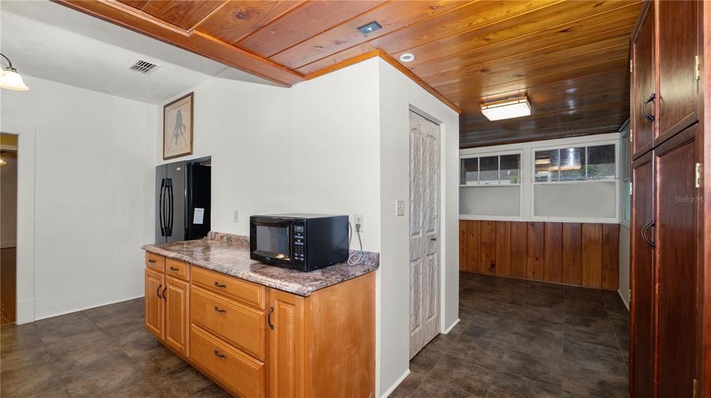 View of kitchen and utility room (L), and flex space and closet pantry (R)