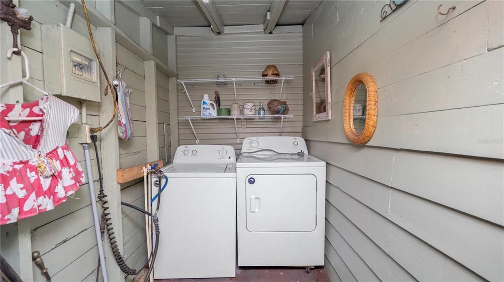 Outdoor laundry room attached to workshop