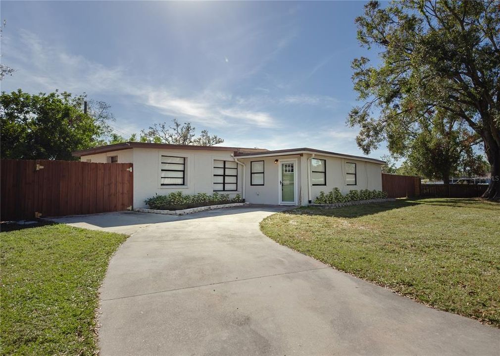 Oversized driveway and additional parking pad by the fence