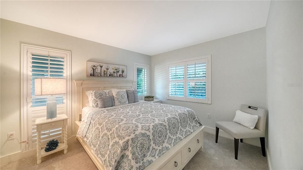 Second guest room showcases updated windows and coastal shutters.