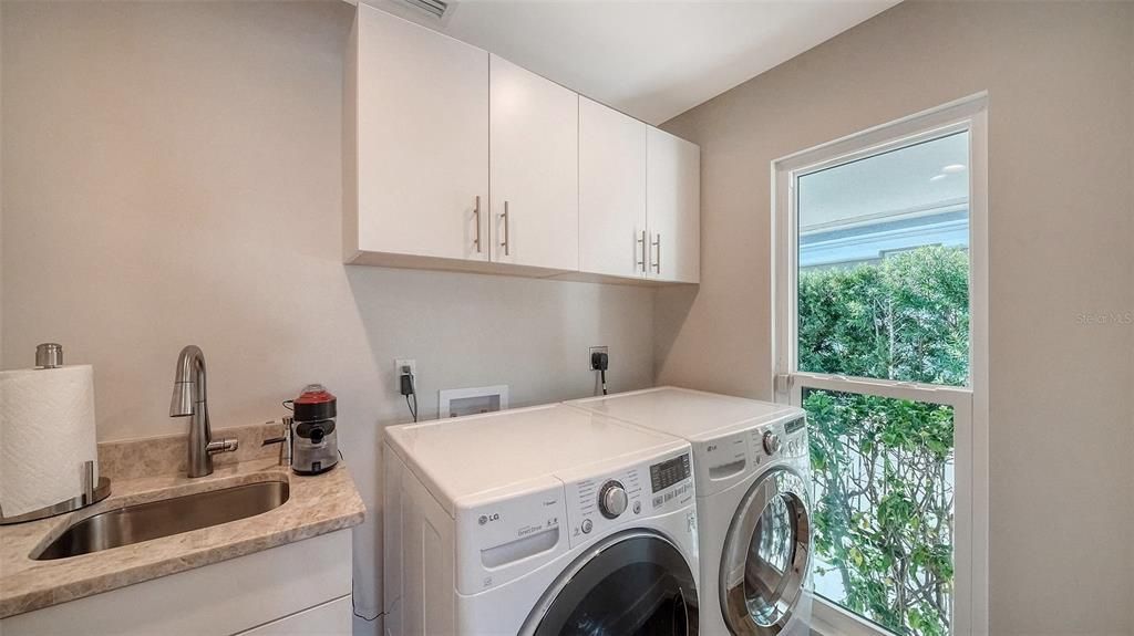 Laundry room with additional storage area.