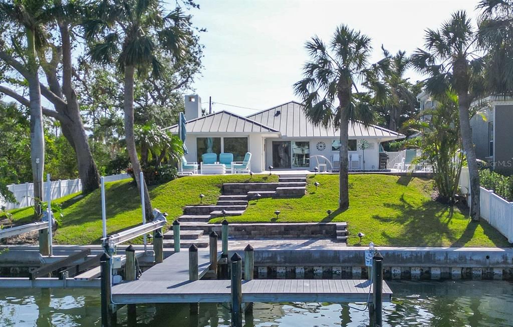 This stunning home is the epitome of coastal contemporary living. Professionally remodeled home offers the perfect blend of luxury, style, and function situated on a private, canal lot with bay access.