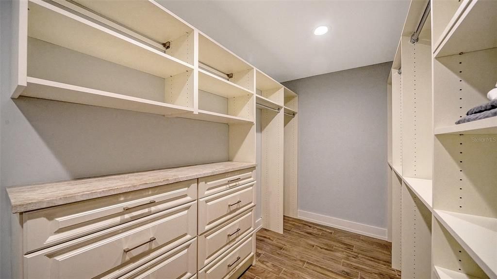 Expansive primary closet with built ins.