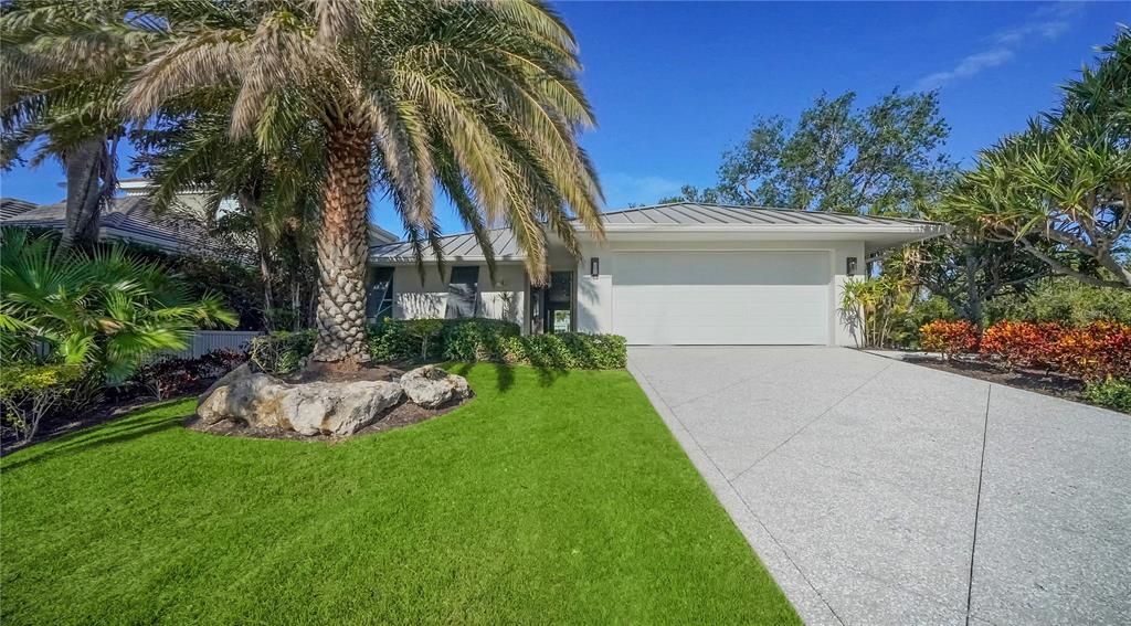 Professionally landscaped elevated lot offers both privacy and picturesque views with its own sprinkler system.  Home also offers new shell stone driveway and walkway.