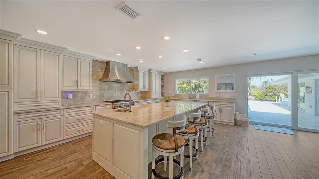 This updated chef's kitchen has custom cabinetry and counters offering plenty of storage space.