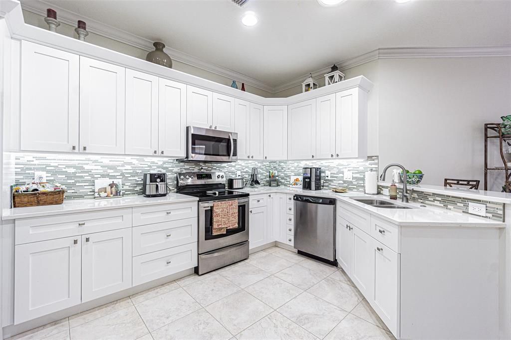 Updated kitchen cabinets, glass tile backsplash, marble countertops and SS appliances