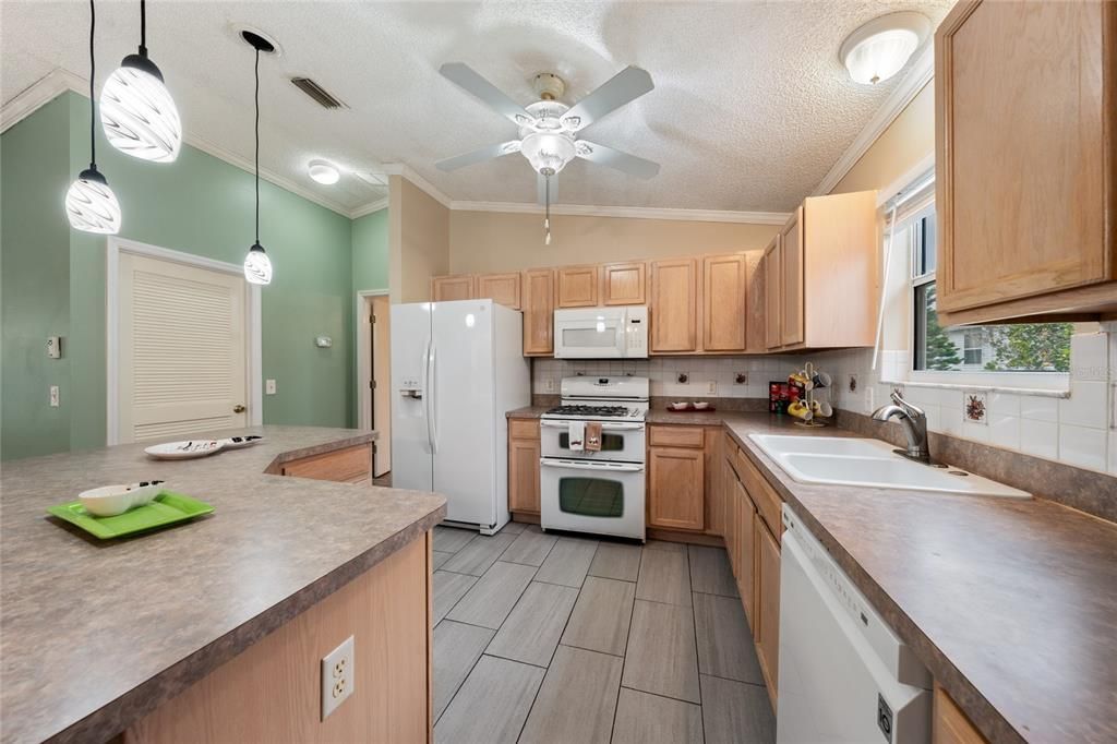 Kitchen has plenty of counter space, double oven, microwave, fridge, & dishwasher.