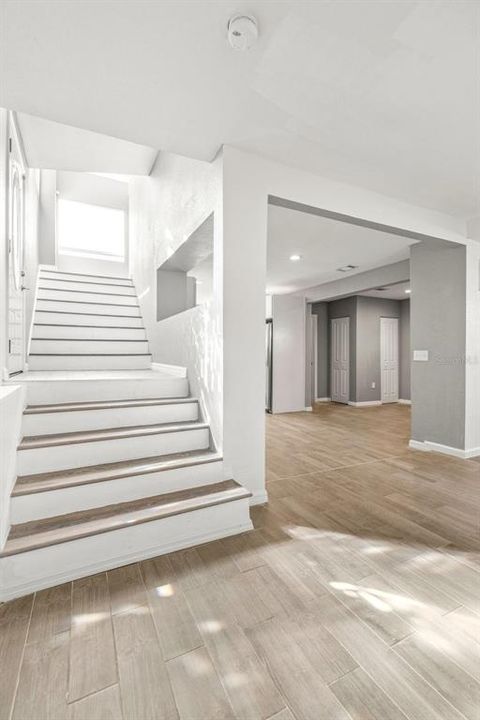 Bright and airy stairs lead to the second floor and all three bedrooms.