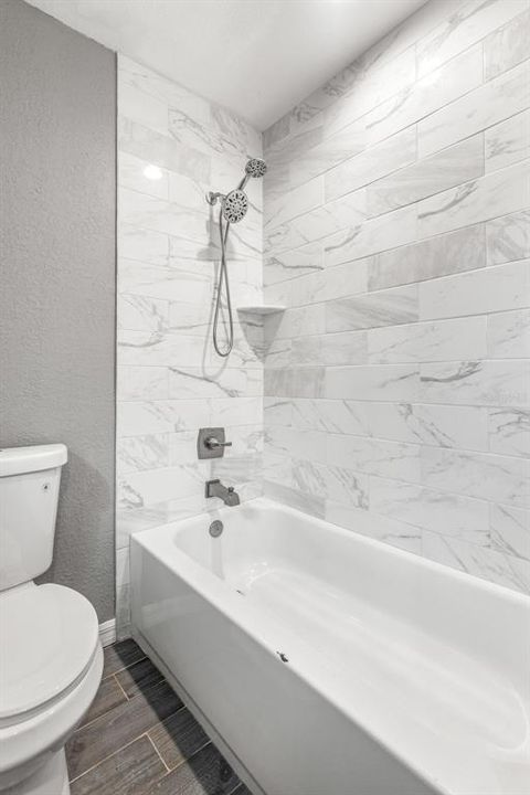 Shower and tub combo with tile surround.