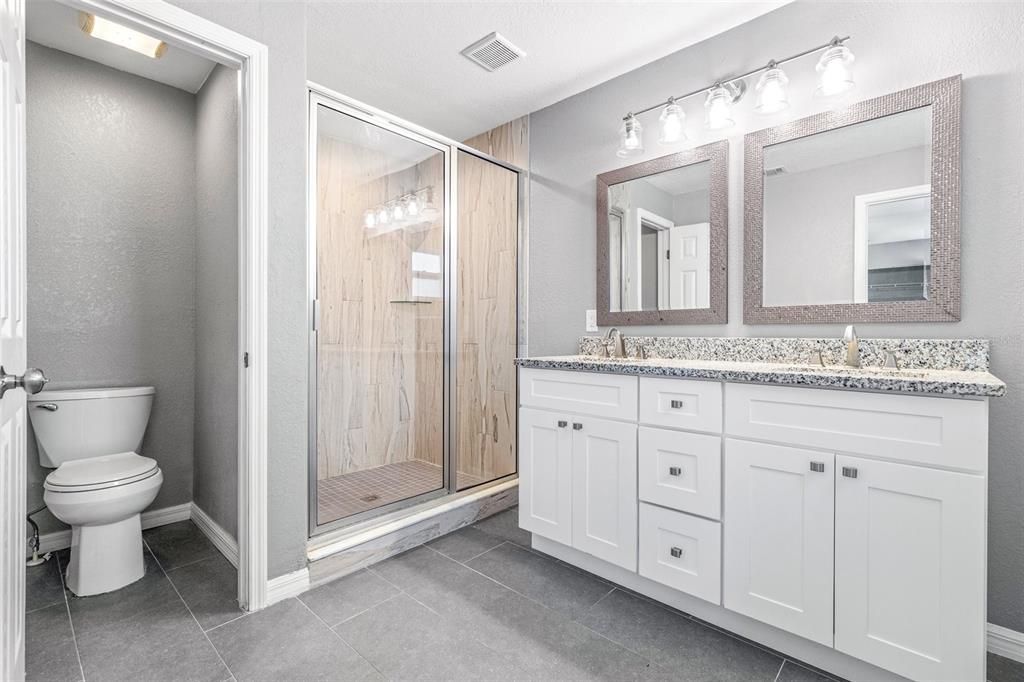 Updated primary ensuite with water closet and dual vanities.