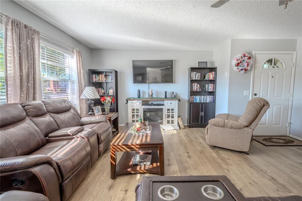 The living room has two large picture windows that let in lots of natural light.