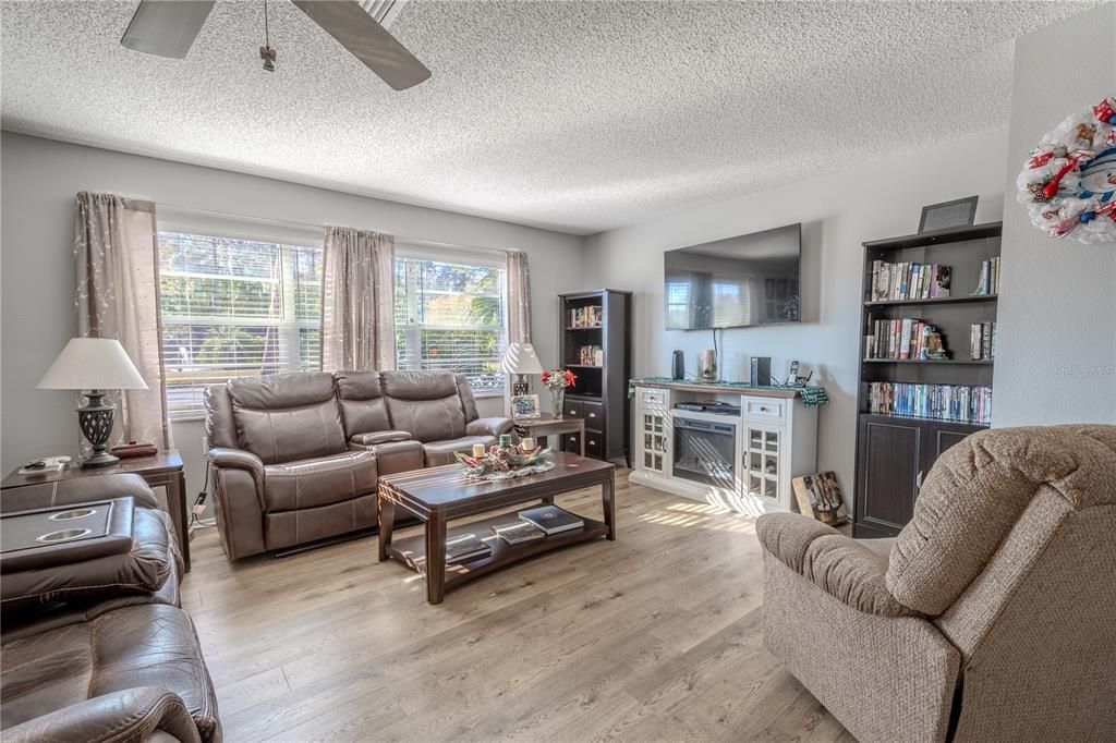 The Living room features a neutral color palette with NEW Pergo Waterproof Laminate Wood Flooring.