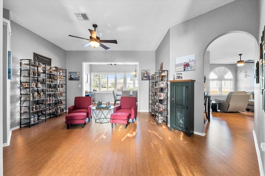 This lovely Sitting Room with solid bamboo floors and arched doorway greets you and your guests at the front entry. Or, you could head to the right and discover the world of the Living Room, Breakfast Nook and Kitchen.