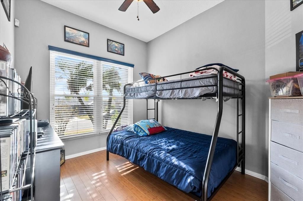 This is the Third Bedroom, with the same solid bamboo flooring, a ceiling fan/light, and a built-in closet.