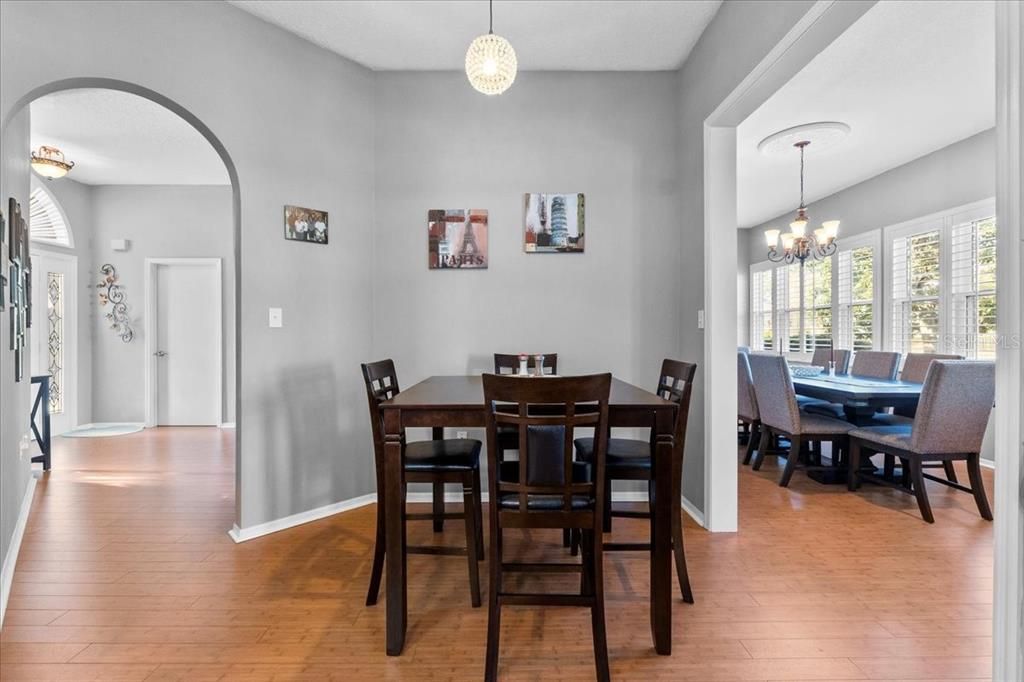 The Breakfast Nook flows into either the Entryway and Sitting Room or the oh-so-roomy Dining Room with plantation shutters and a view of the tranquil back yard.