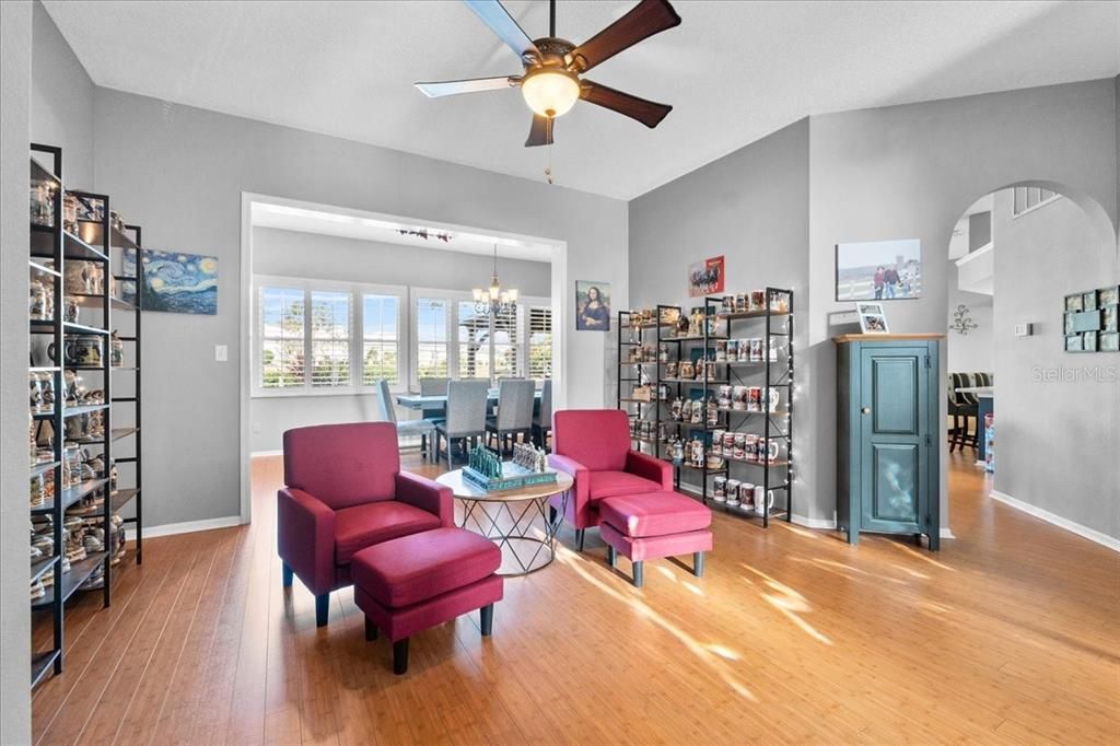 This lovely Sitting Room with solid bamboo floors and arched doorway greets you and your guests at the front entry.