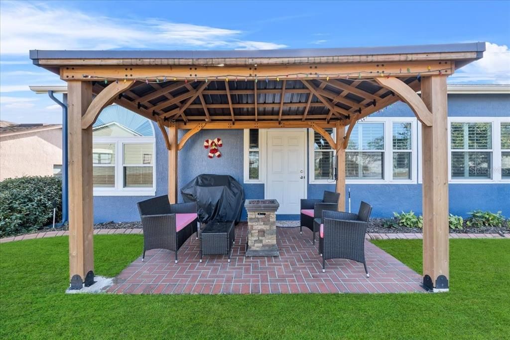 Brick-pavered pergola area faces West toward the sunset