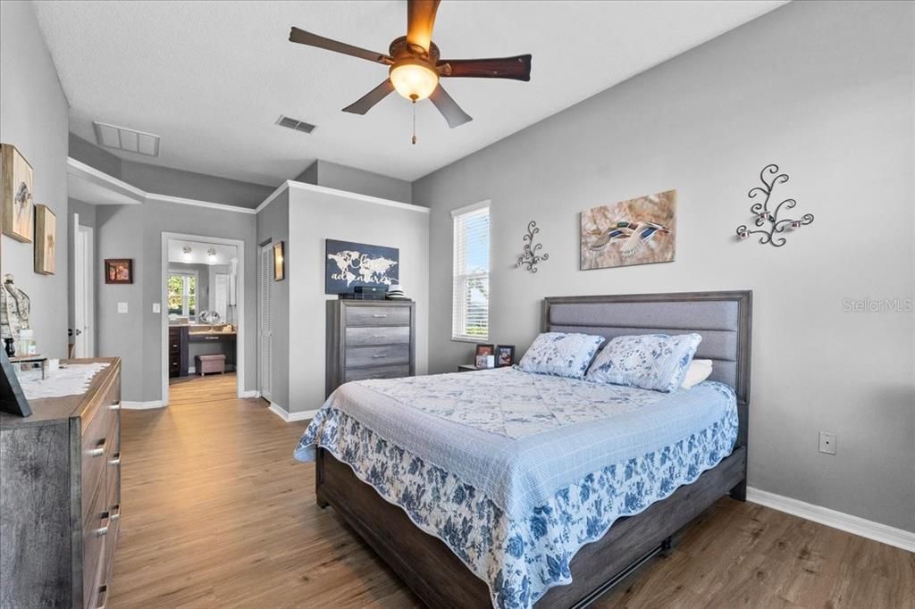 This giant 22' x 11' Owners' Oasis sports the same handsome wood-look luxury vinyl plank flooring as the Second Bedroom, high ceilings, a ceiling fan/light, and of course the ensuite bath.