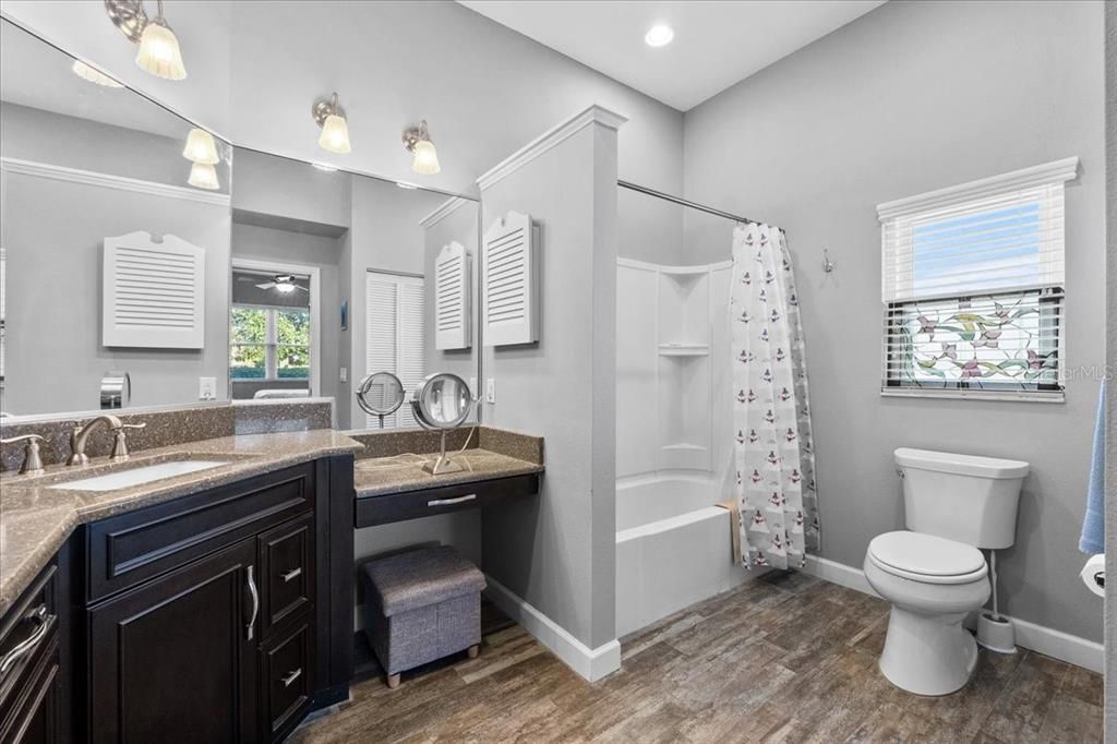 This is the Owner's Oasis Ensuite Bath, with ceramic tile flooring, a tub/shower combo, a makeup station, lots of light, a linen closet, and a very upscale above-counter cabinet for all the quick access items you can think of.