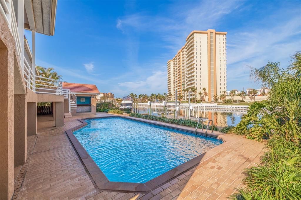 Gorgeous water views of pavered pool area overlooking canal