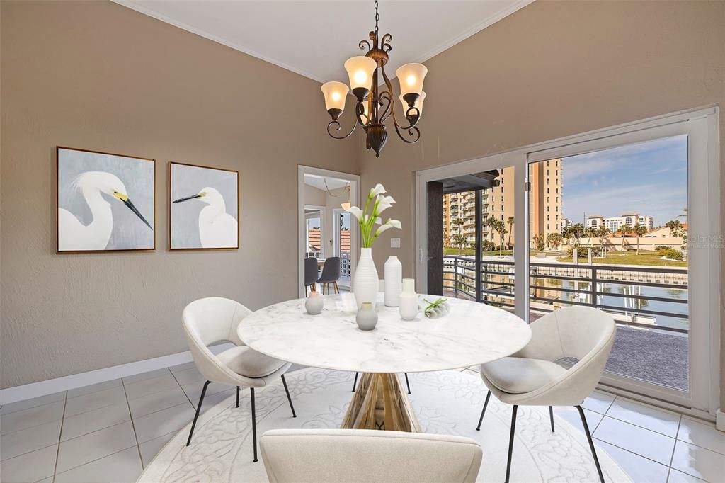 View to outdoor balcony from dining room. This photo has been virtually staged.