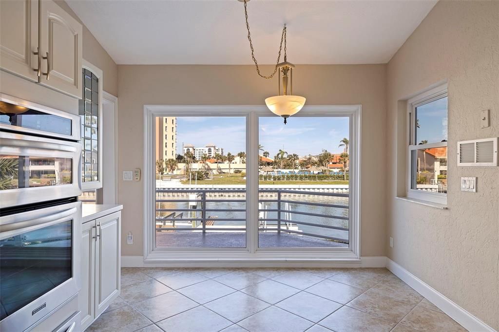 Kitchen with view of eat-in space and balcony access.