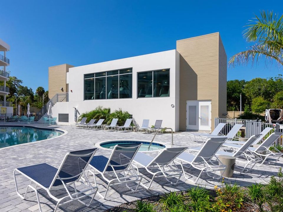 Well equipped fitness center looking over pool