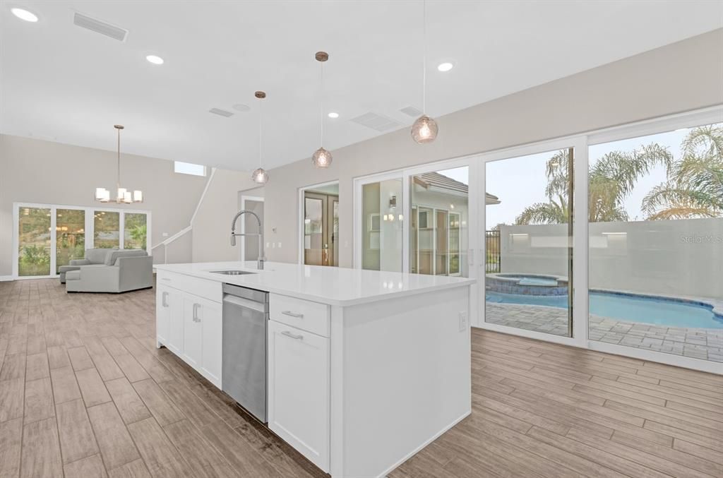 Kitchen area has the view of the outdoor pool