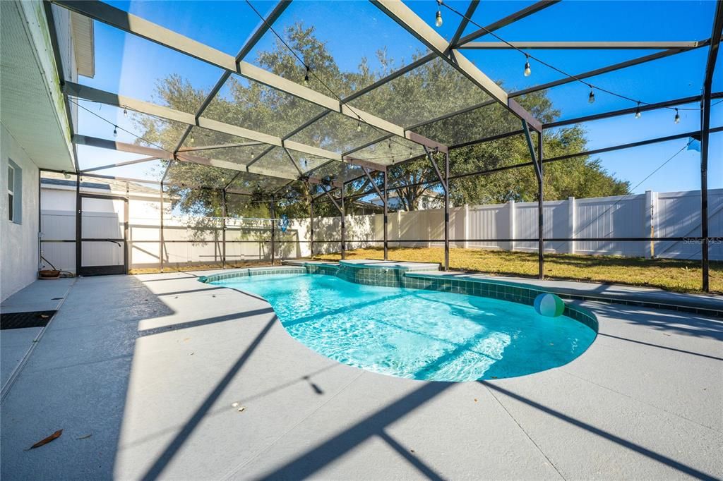 our SCREENED POOL is surrounded by a deck for a variety of seating options all overlooking a FULLY FENCED backyard for added privacy.