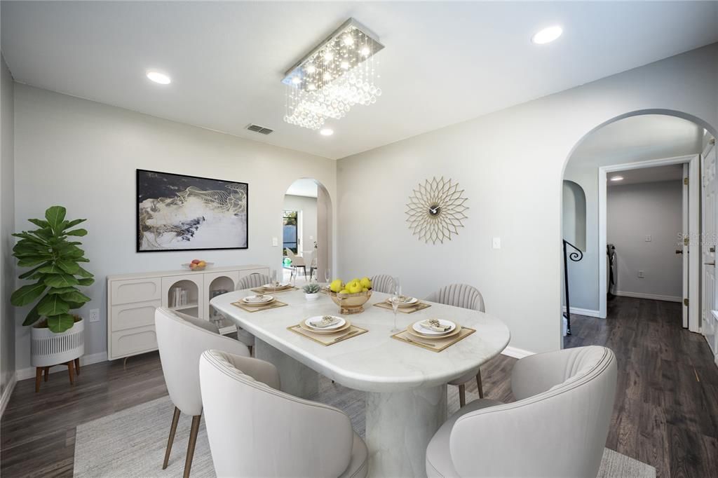 This flowing floor plan features a formal dining space with a large picture window for great natural light and a chic chandelier; entertain family and friends with ease and the ease of access to the large living area, open kitchen and the foyer. Virtually Staged.