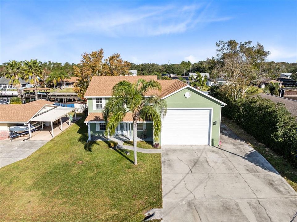 View of front of property. Very long driveway and side driveway to back yard and back garage door