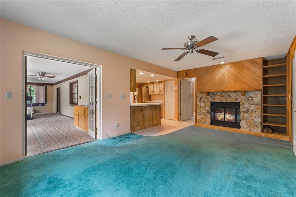 Family Room with decorative fireplace and shelves