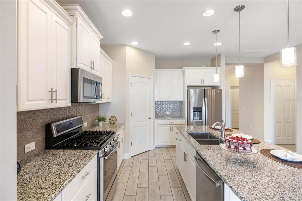 well equipped kitchen with soft toned cabinets