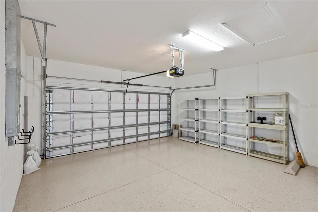 Garage with epoxy flooring and storage shelves