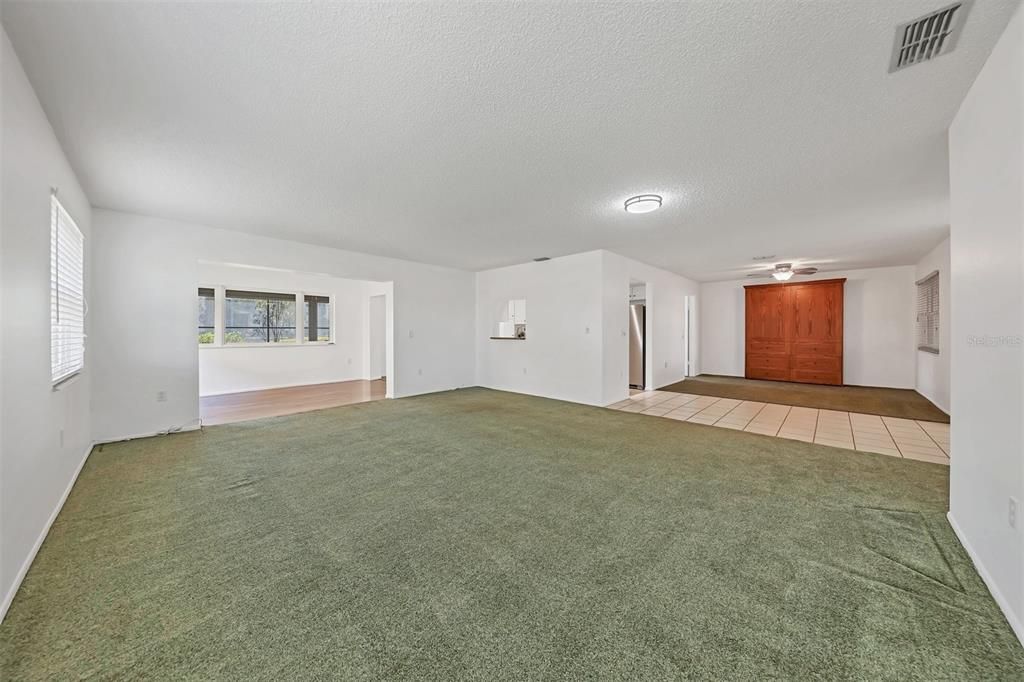 Living room showing connection to dining room at left and bonus room to right.