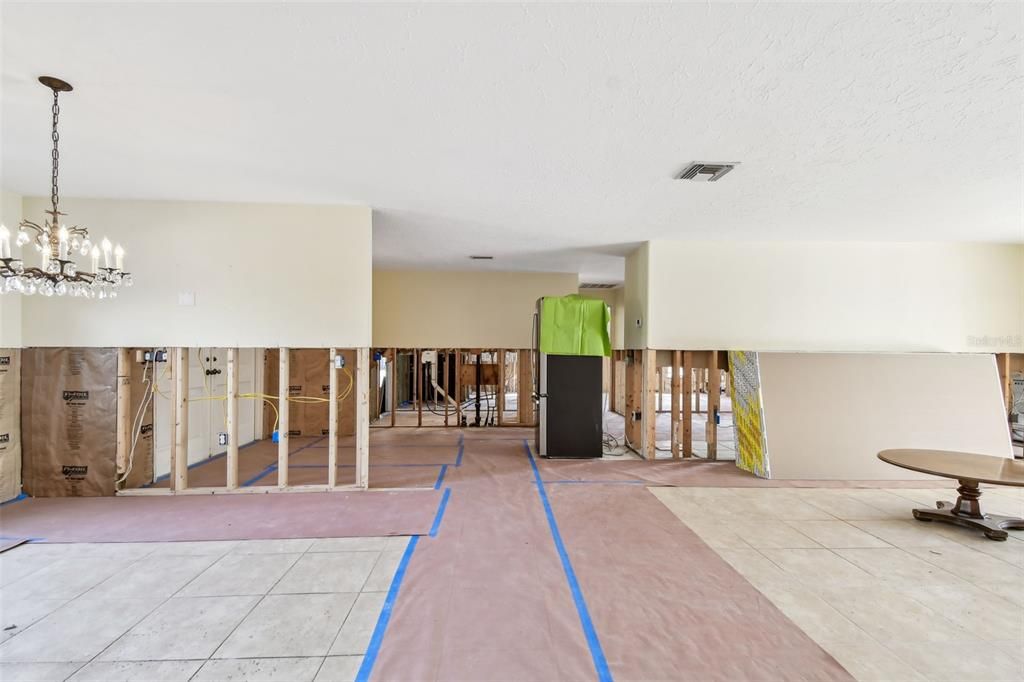 Dining room and living room.  The entry is beyond the half wall to the left and the kitchen is to the right of the refrigerator which is situated in the entry.