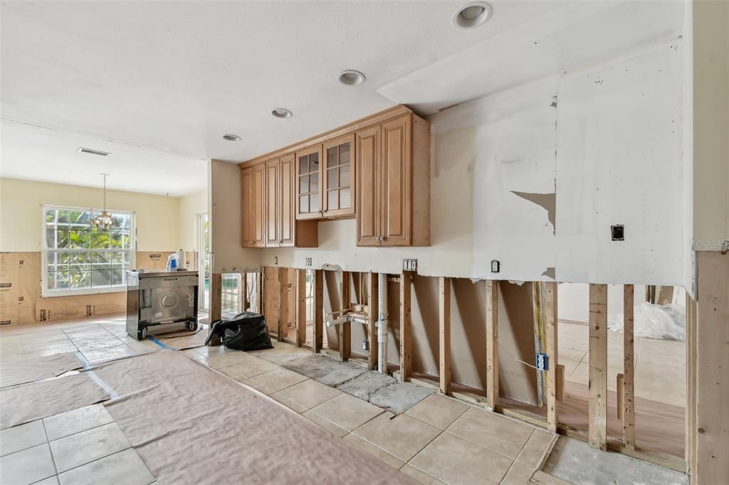 Kitchen with the dining area and family room beyond.  Sliding glass doors lead out to the pool.