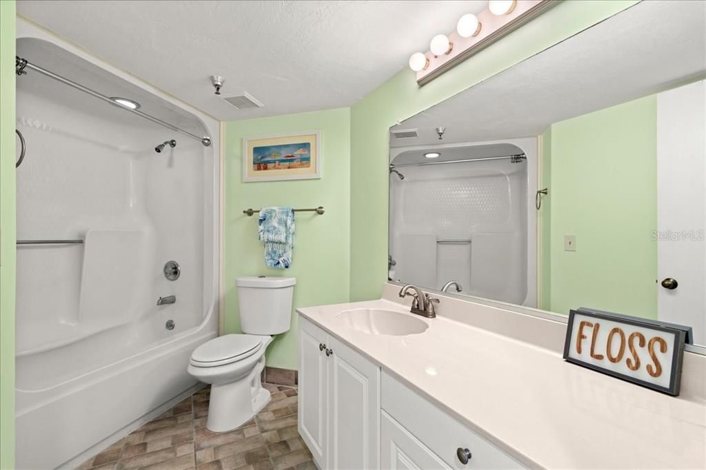 Hall bathroom with shower and tub