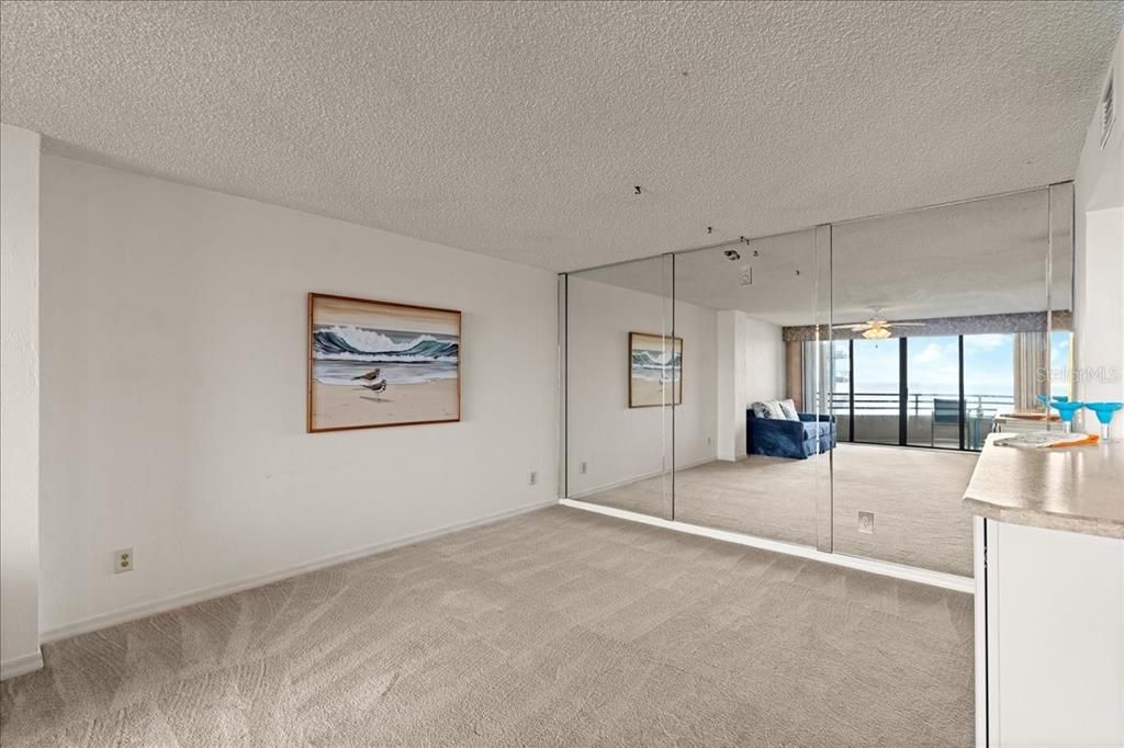 Spacious dining area with mirrored wall