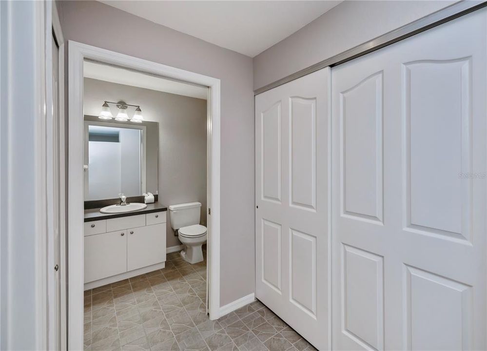 Guest bath is adjacent to the guest bedroom. Utility closet with washer/dryer behind the bi-fold doors.