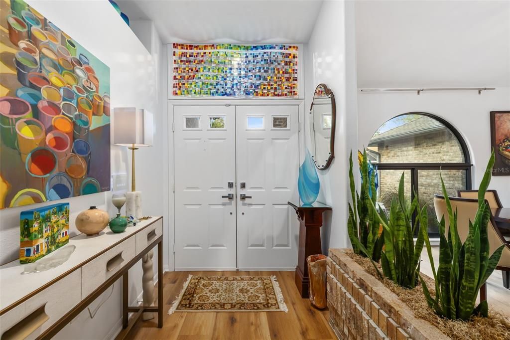 Foyer features built in planter of brick