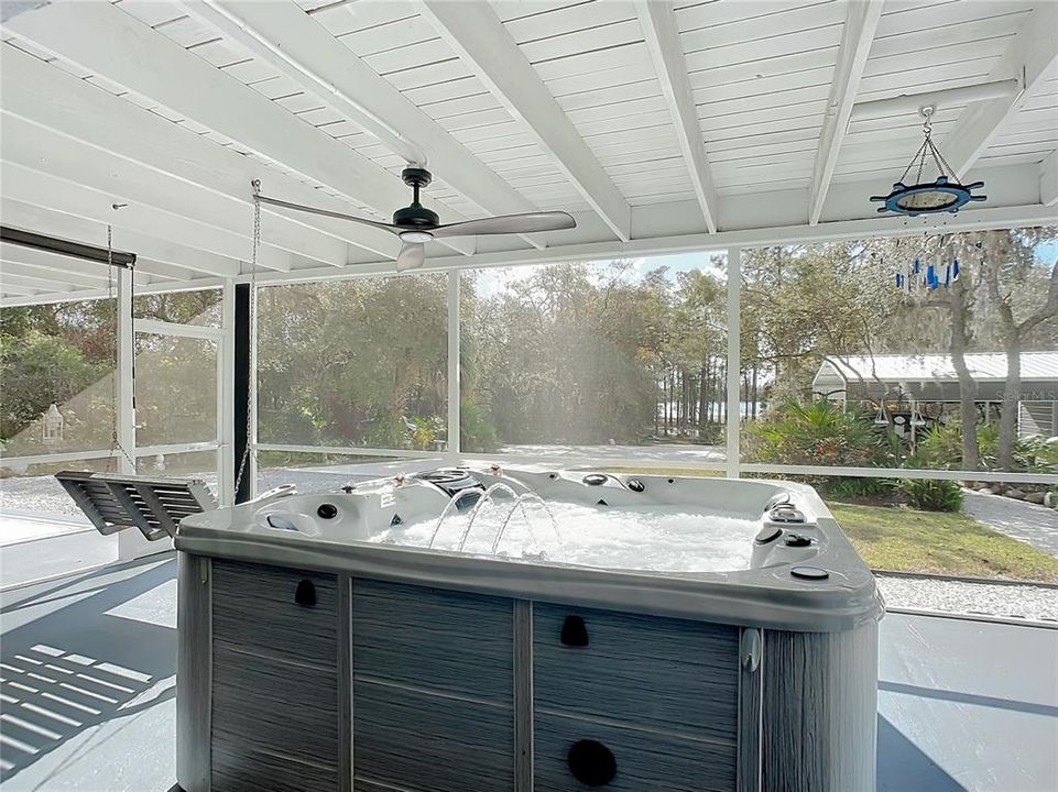 Hot tub overlooking yard and lake